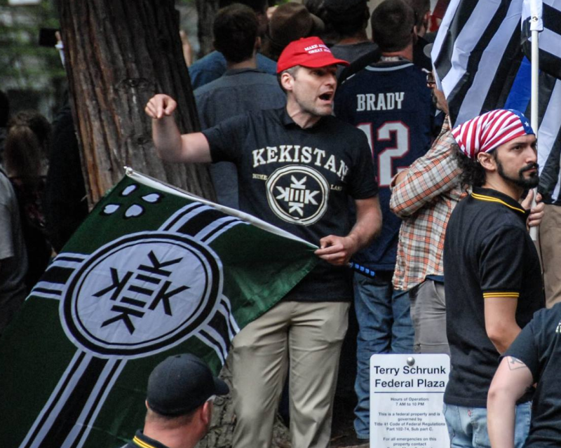 a participant at Joey Gibson's June 4th rally flies a pallet swapped nazi flag