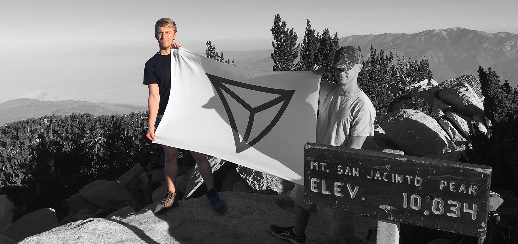 Alex Loupe holds an Identity Europa flag