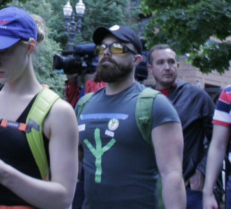 A participant in Joey Gibson’s 6/4 rally displays nazi occultist utilizations of Algiz as the life rune