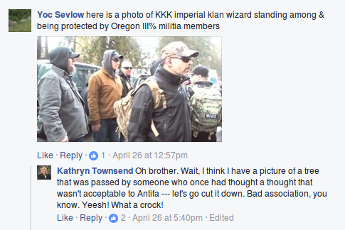 Kathryn Townsend brushes off a photograph of right wing militia members protecting KKK Imperial Wizard Steven Shane Howard at a Trump rally in Lake Oswego